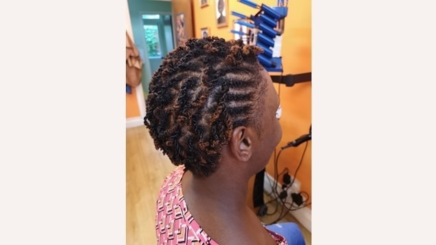 mulher com crespo curto e twists exibe um penteado moderno e cheio de estilo.