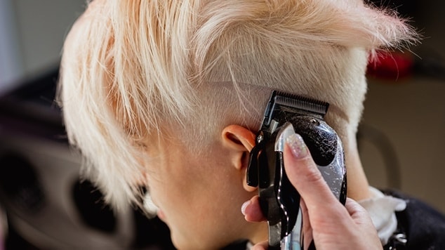 Mulher com corte pixie clássico, cabelo descolorido.